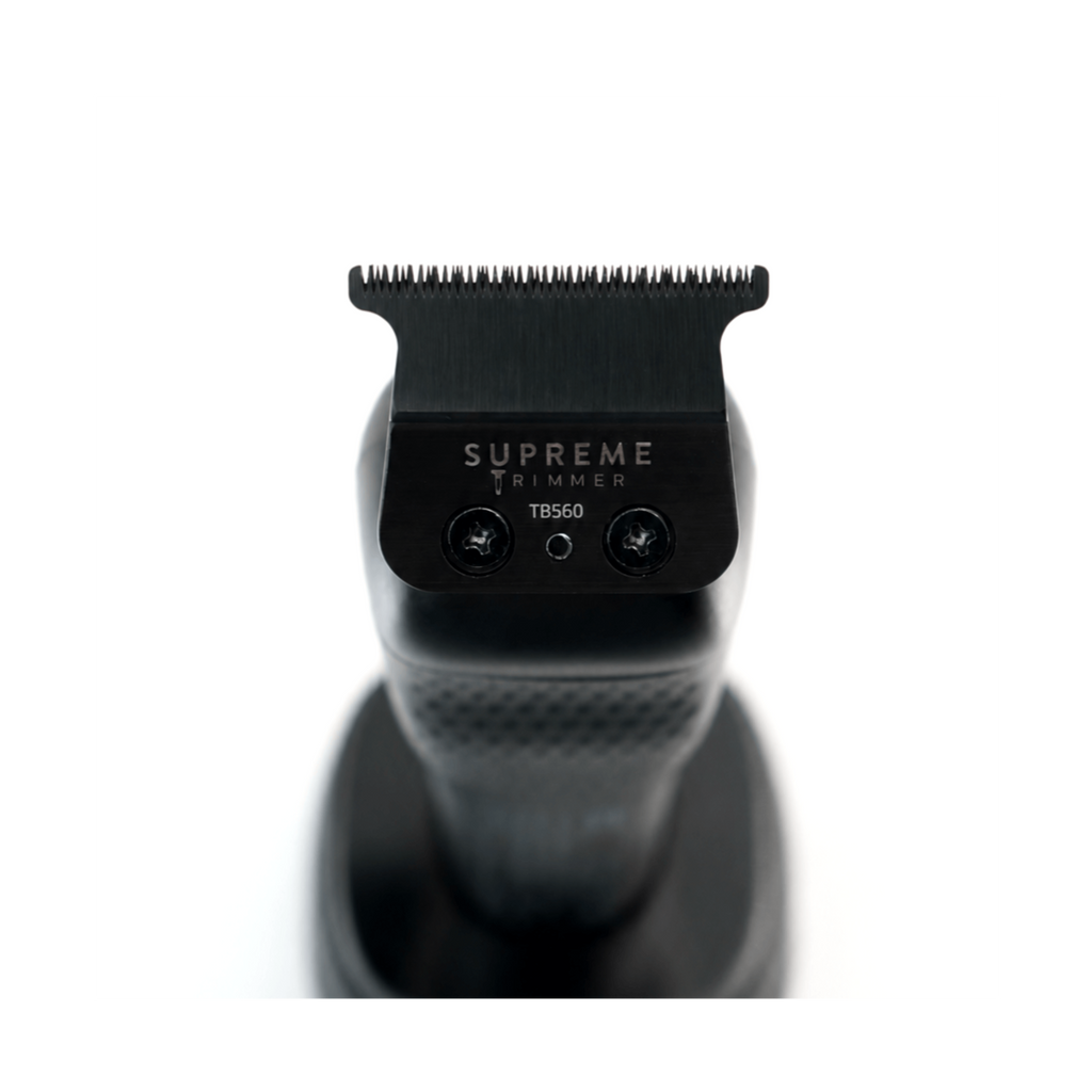 Supreme Trimmer TB560 deep-tooth T-blade installed on a professional hair trimmer, showing the cutting head and blade design.